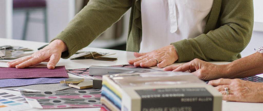 Zwei Frauen bewerten eine Auswahl an Stoffmustern